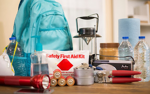 Emergency preparedness supplies. A large collection of supplies to be used in case of a natural disaster (hurricane, flood, earthquake, etc) including flashlight, backpack, batteries, water bottles, first aid kit, lantern, radio, can opener and mask. No People.
