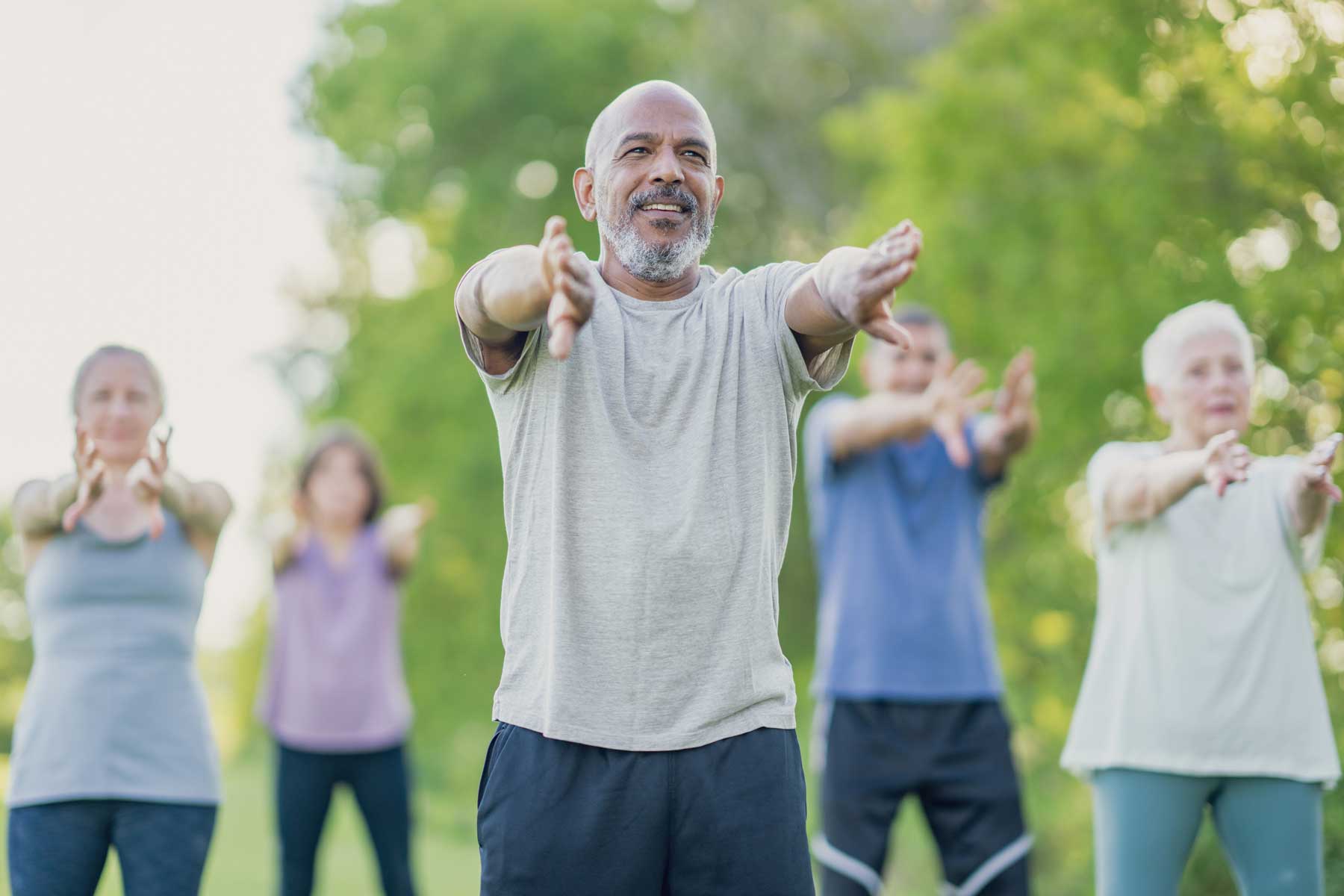 seniors outside practicing Tai Chi