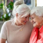 a senior woman smiling at her adult daughter