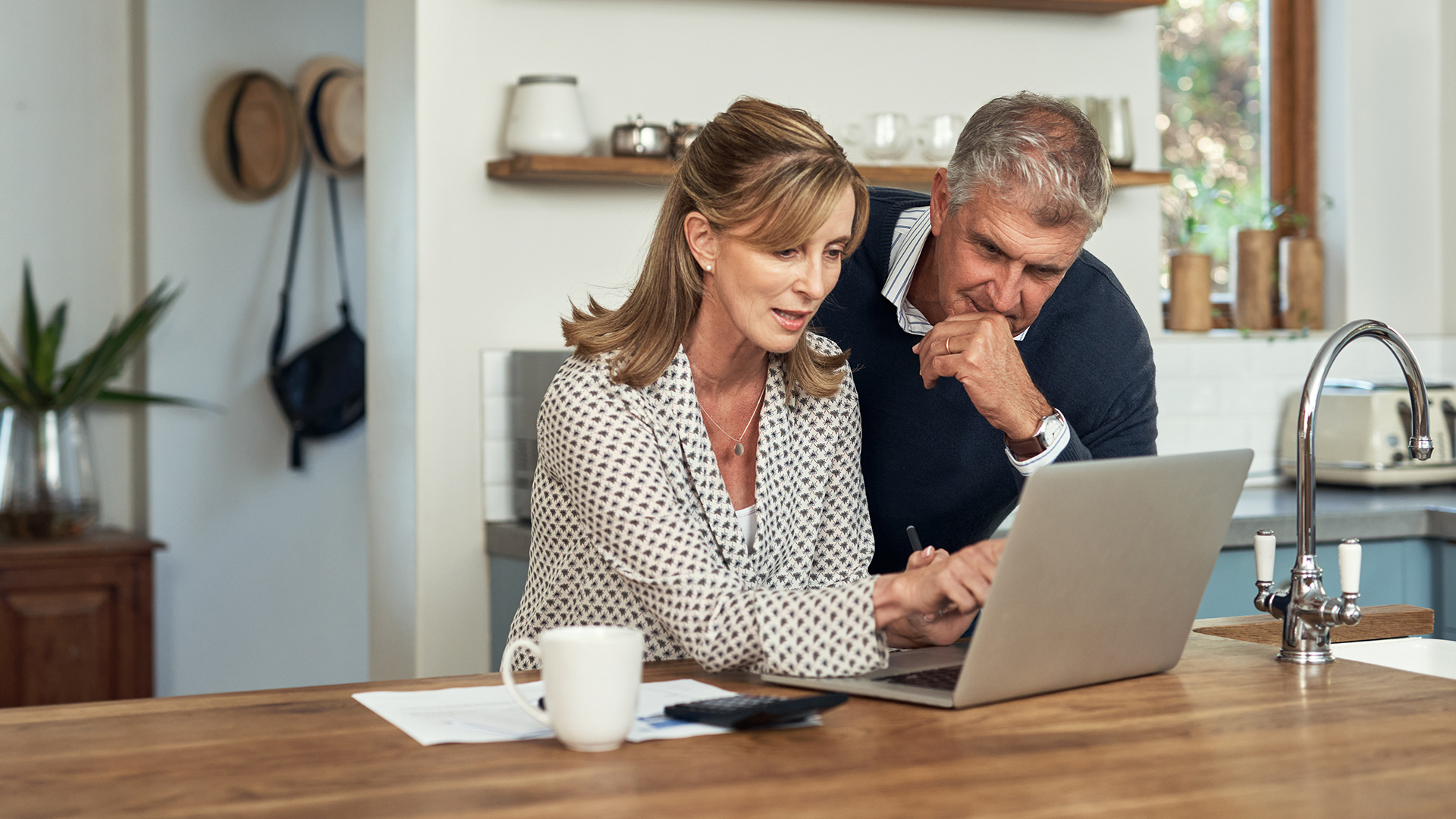 senior couple looking at the tax benefits of retirement communities on their computer