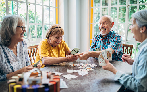 seniors playing card games that help cognitive function together