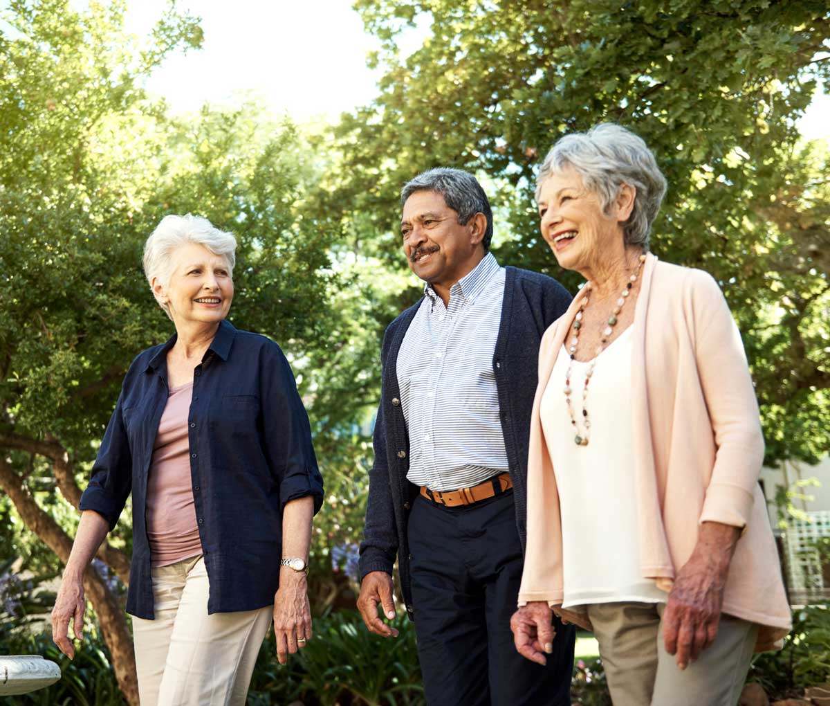 Group of smiling seniors walking outdoors